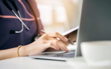 A close-up of a hand on a computer Description automatically generated